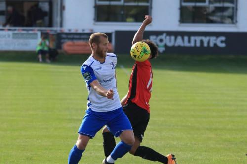 Enfields Sam Hatton (L) knocks the ball past Nico Cotton