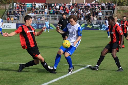 Lewes Frankie Chappell (L) clears from Sam Chaney watched by Omarr Lawson