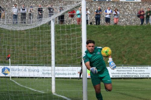 Lewes keeper Lewis Carey tries to keep the ball in play, unsuccessfully according to the linesman on the far side