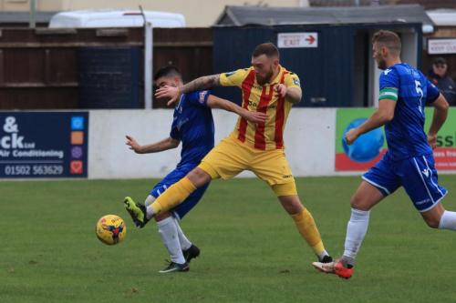 Enfields Billy Bricknell (centre) challenges Matt Brown