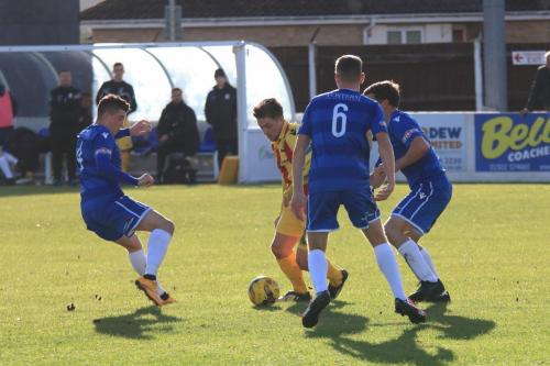 Enfields Lewis Taaffe is surrounded by Henry Pollock (L), Matt Castellan and Adam Tann (R)