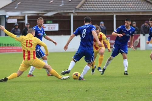 Enfields Liam Hope (15) stretches to challenge Connor Deeks