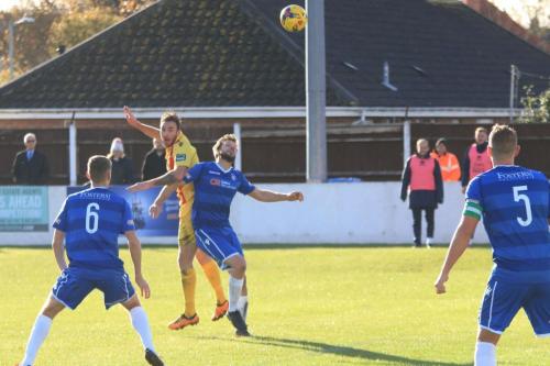 Enfields Matt Johnson (yellow) challenges Adam Tann