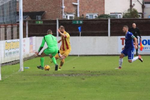 Enfields Sam Hatton (following up his own shot) tries to cut the ball back to a teammate