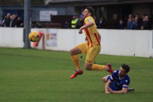 Lowestofts Adam Tann (R) tackles Remi Sutton