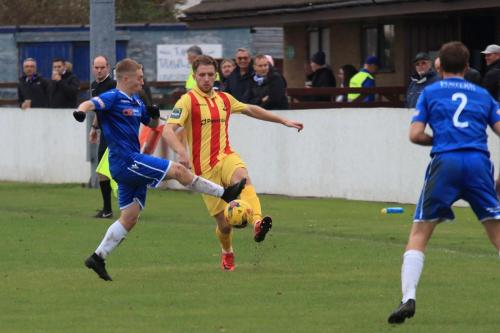 Lowestofts Conor McKendry (L) challenges Remi Sutton