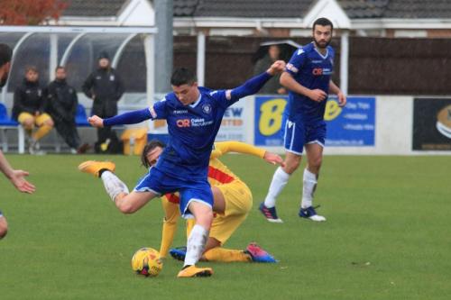 Lowestofts Hanry Pollock clears from Sam Youngs