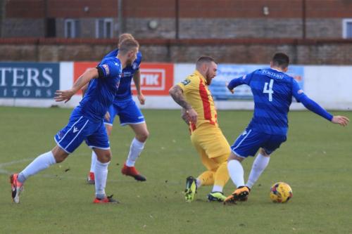 Lowestofts Henry Pollock (4) tackles Billy Bricknell