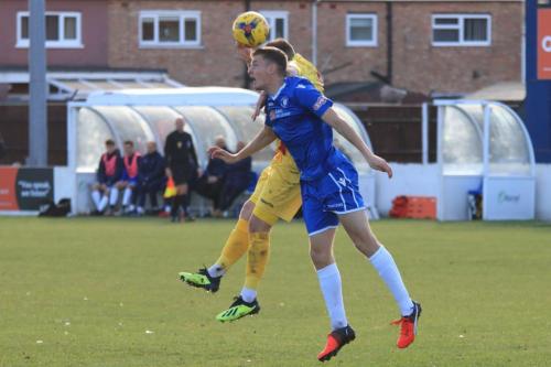 Lowestofts Matt Castellan (blue) challenges Billy Bricknell