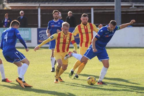 Lowestofts Rossi Jarvis (R) clears for a corner