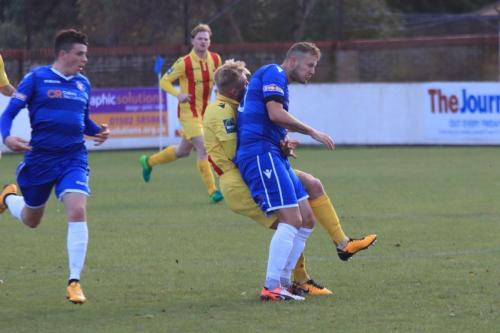 Lowestofts Rossi Jarvs (R) blocks Ryan Blackmans run