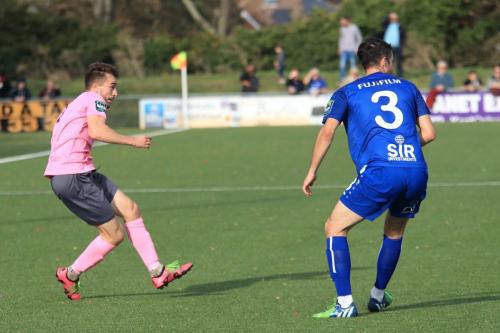 Enfields Bilal Sayoud (L) crosses past Tom Mills