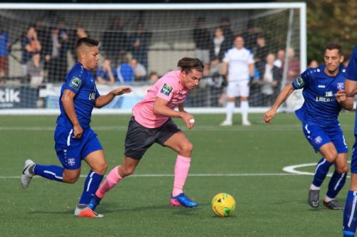 Enfields Sam Youngs runs past Jordy Robins (L) as Lee Prescott tries to cover