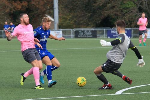 Margate keeper Henry Newcombe clears from Billy Bricknell (L) and Ben Swift