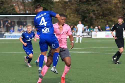 Margates Jordy Robins (blue) heads clear from Taofiq Olomowewe