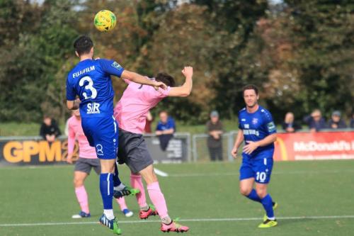 Margates Tom Mills (blue) heads clear from Bilal Sayoudx