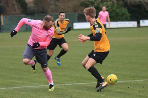 Enfields Billy Bricknell (L) flicks the ball past Oliver Cook