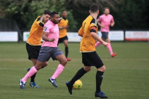 Enfields Kezie Ibe and Mersthams Tom Kavanagh (L) and Simon Cooper