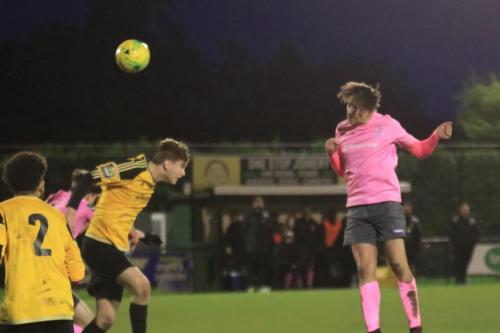 Enfields Sam Youngs (R) heads just over