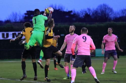 Merstham keeper Amadou Tangara catches a cross
