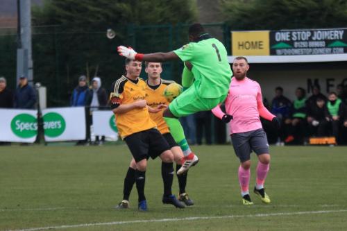 Merstham keeper Amadou Tangara kicks clear