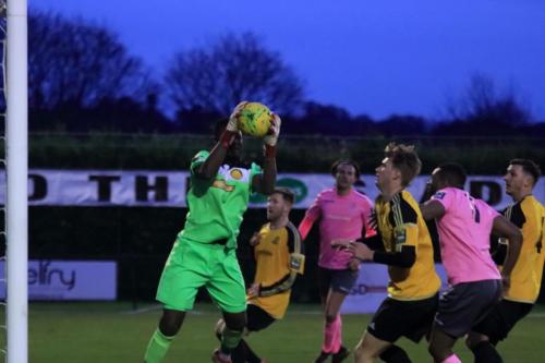 Merstham keeper Amadou Tangara saves