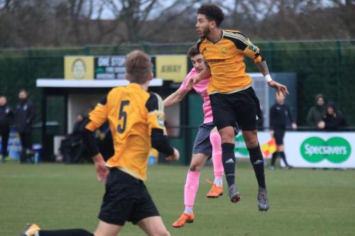 Mersthams Harry Osborne (R) heads clear from Bilal Sayoud