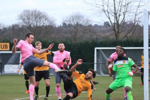 Mersthams Harry Osborne (amber) clears from Matt Johnson