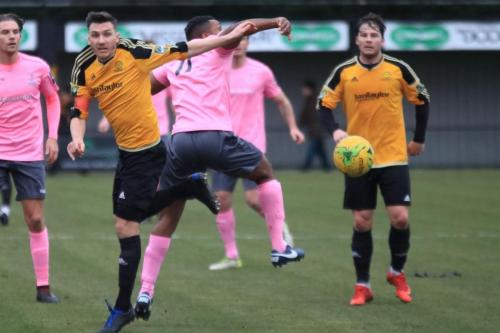 Mersthams Tom Kavanagh (amber, L) challenges Kezie Ibe
