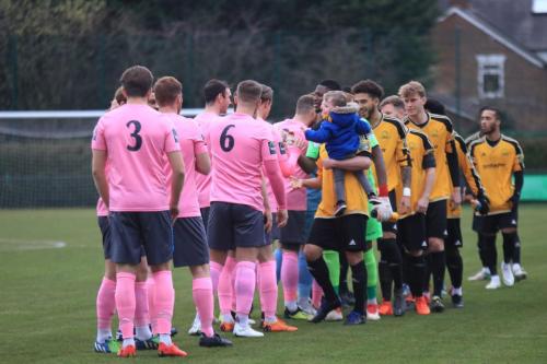 Mersthams captain Simon Cooper carried the young mascot for the pre-game handshakes
