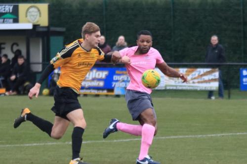 Unseen by the officials, Mersthams Oliver Cook pulls Kezie Ibes shirt in the penalty area