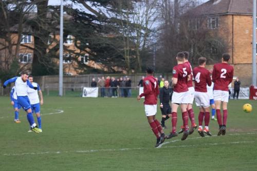 Billy Bricknell fires a free kick past the Potters Bar wal  forcing a save from keeper Berkley Laurencin