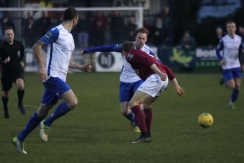 Enfields Aaron Greene runs at Lewis Hobbs (maroon)