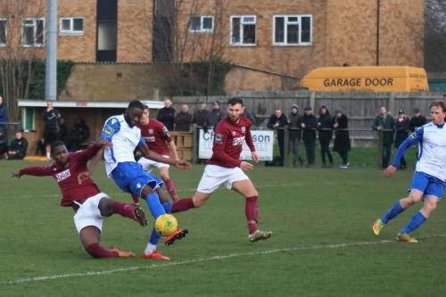 Enfields Muhammadu Faal slices his shot wide under pressure from Stefan Powell (L)