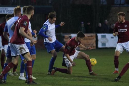 Enfields Sam Youngs (white  centre) challenges Sean Grace