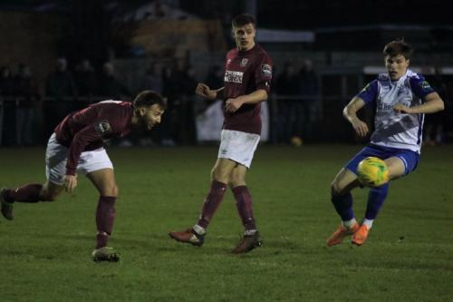 Potters Bars Andrew Lomas (L) heads clear from Josh Davison