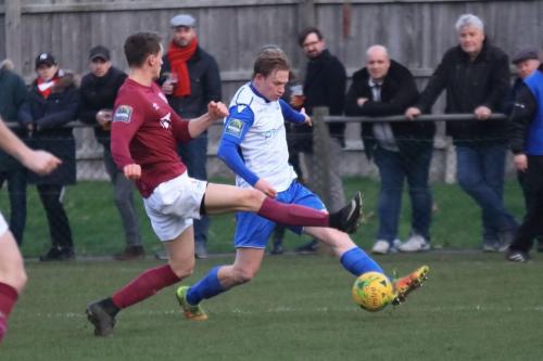 Potters Bars Lewis Hobbs (maroon) challenges Aaron Greene