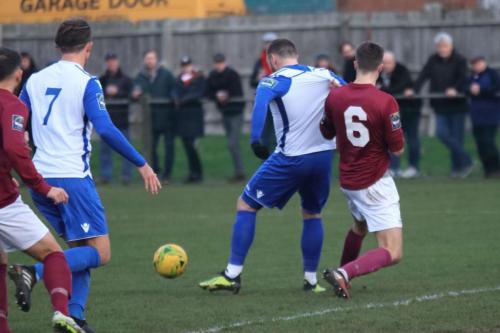 Potters Bars Sean Grace (6) challenges Billy Bricknell