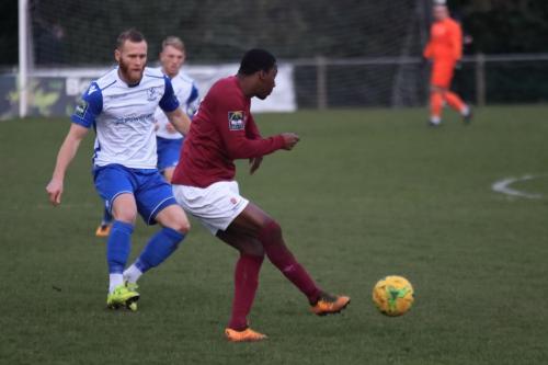 Potters Bars Stefan Powell (R) clears from Sam Hatton