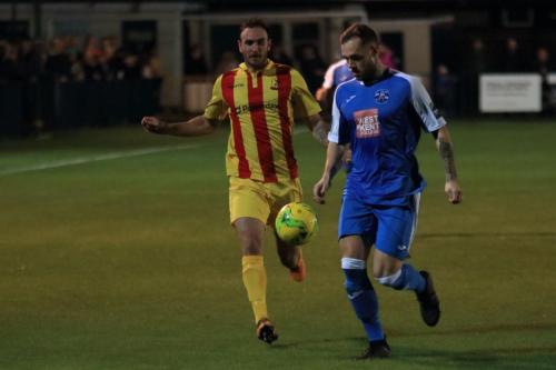 Tonbridges Arthur Lee (blue) clears from Matt Johnson