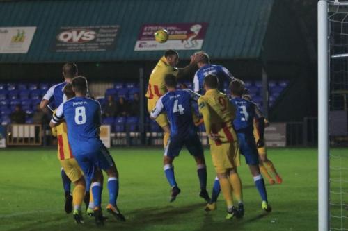 Tonbridges Tom Beere (15) heads clear from Matt Johnson