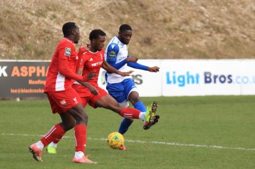 Enfield Muhammadu Faal shoots past Aaron Goode (L) and SinnKaye Christie