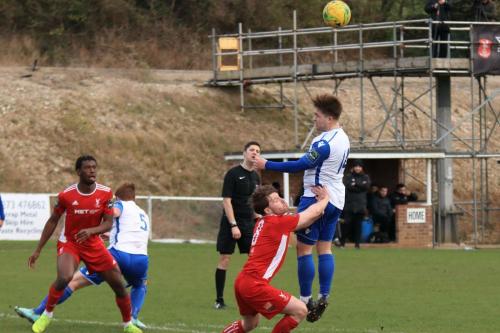 Enfields Lewis Taaffe (R) wins a header against John Paul Kissock