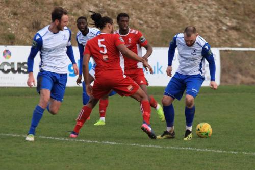 Whitehawks Yannis Ambroisine (5) gets his foot to the ball just ahead of Billy Bricknell
