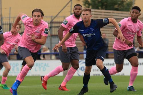 Enfields Sam Youngs (L) and Wingates Rob Laney lead the rush at a set piece