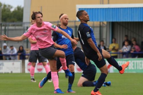 Enfields Sam Youngs and Wingates Scott Shulton and Tommy Tejan-Sie (L) watch as Youngs shot clears the bar