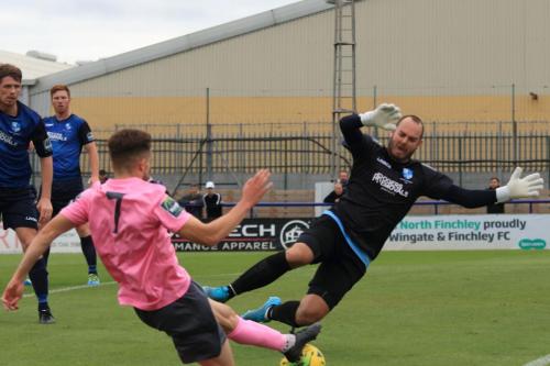 Wingate keeper Shane Gore saves from Bilal Sayoud who had been ruled offside