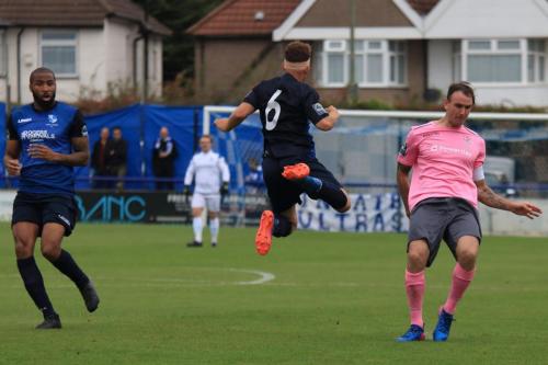 Wingates Marc Charles-Smith (L) and Scott Shulton and Enfields Matt Johnson