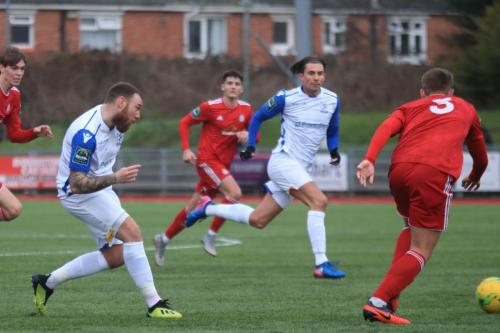 Enfields Billy Bricknell (white,L) passses across the Worthing box