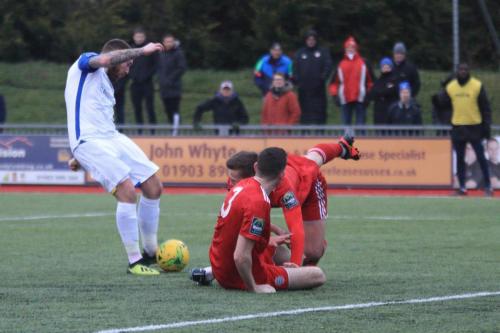 Enfields Billy Bricknell gets a shot away despite the efforts of James Crane (3) and Joel Colbran